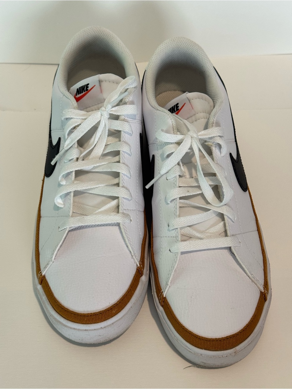Nike White Sneakers with Brown Trim and Black Swoosh